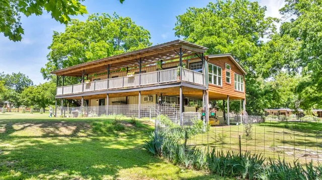 a front view of a house with a yard table and chairs