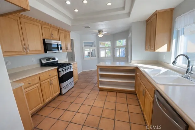 a kitchen with a sink a stove and cabinets