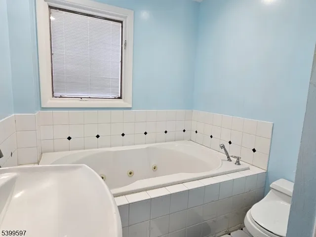 a bathroom with a bathtub and a toilet