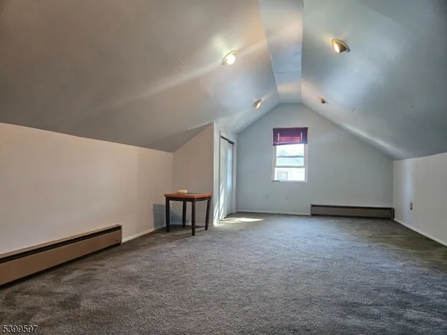 a view of backyard with swimming pool and seating space