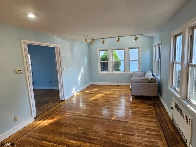 a living room with furniture window and wooden floor