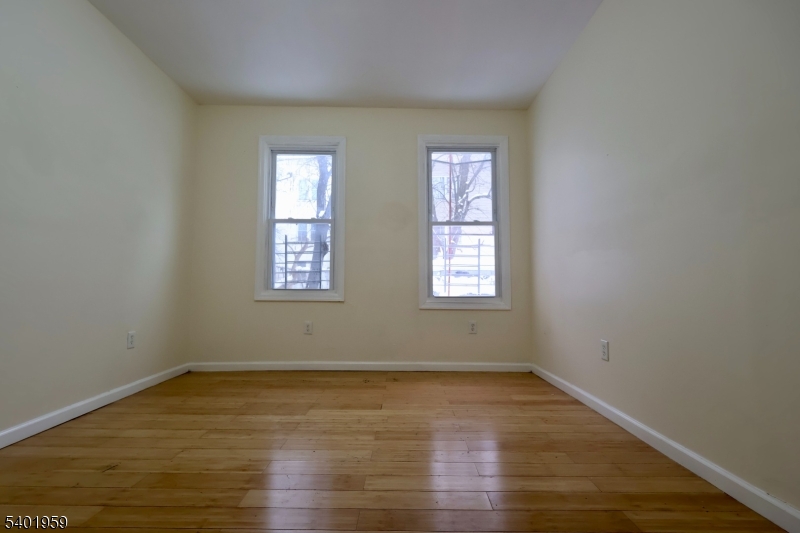 14 Wainwright Street, Unit 1 Newark, NJ 07112 - Photo 11 of 17 an empty room with wooden floor and windows