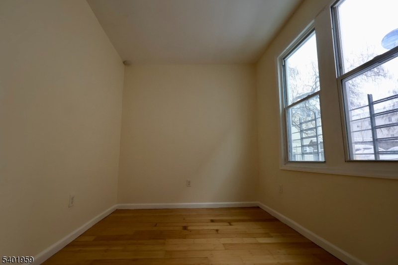 14 Wainwright Street, Unit 1 Newark, NJ 07112 - Photo 15 of 17 an empty room with wooden floor and windows