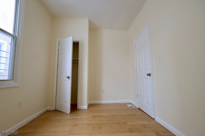 14 Wainwright Street, Unit 1 Newark, NJ 07112 - Photo 16 of 17 a view of an empty room with wooden floor and closet