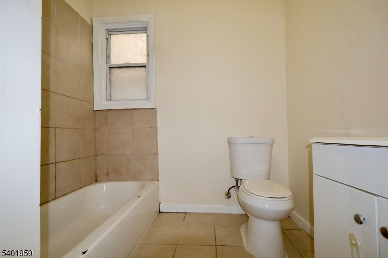 14 Wainwright Street, Unit 1 Newark, NJ 07112 - Photo 9 of 17 a bathroom with a toilet and bathtub