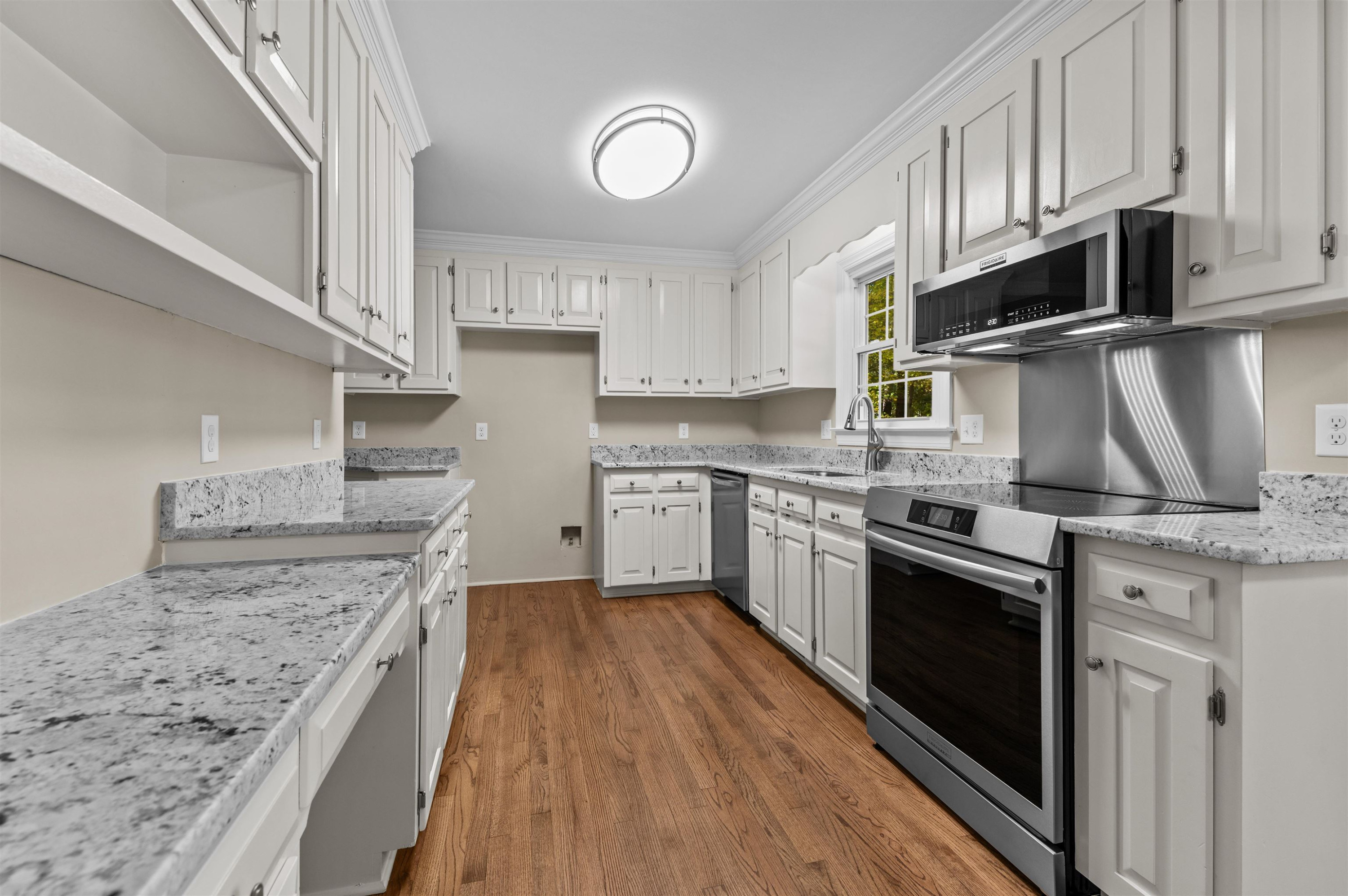 3000 Daventry Lane Raleigh, NC 27613 - Photo 12 of 54 a kitchen with stainless steel appliances granite countertop a stove sink and cabinets