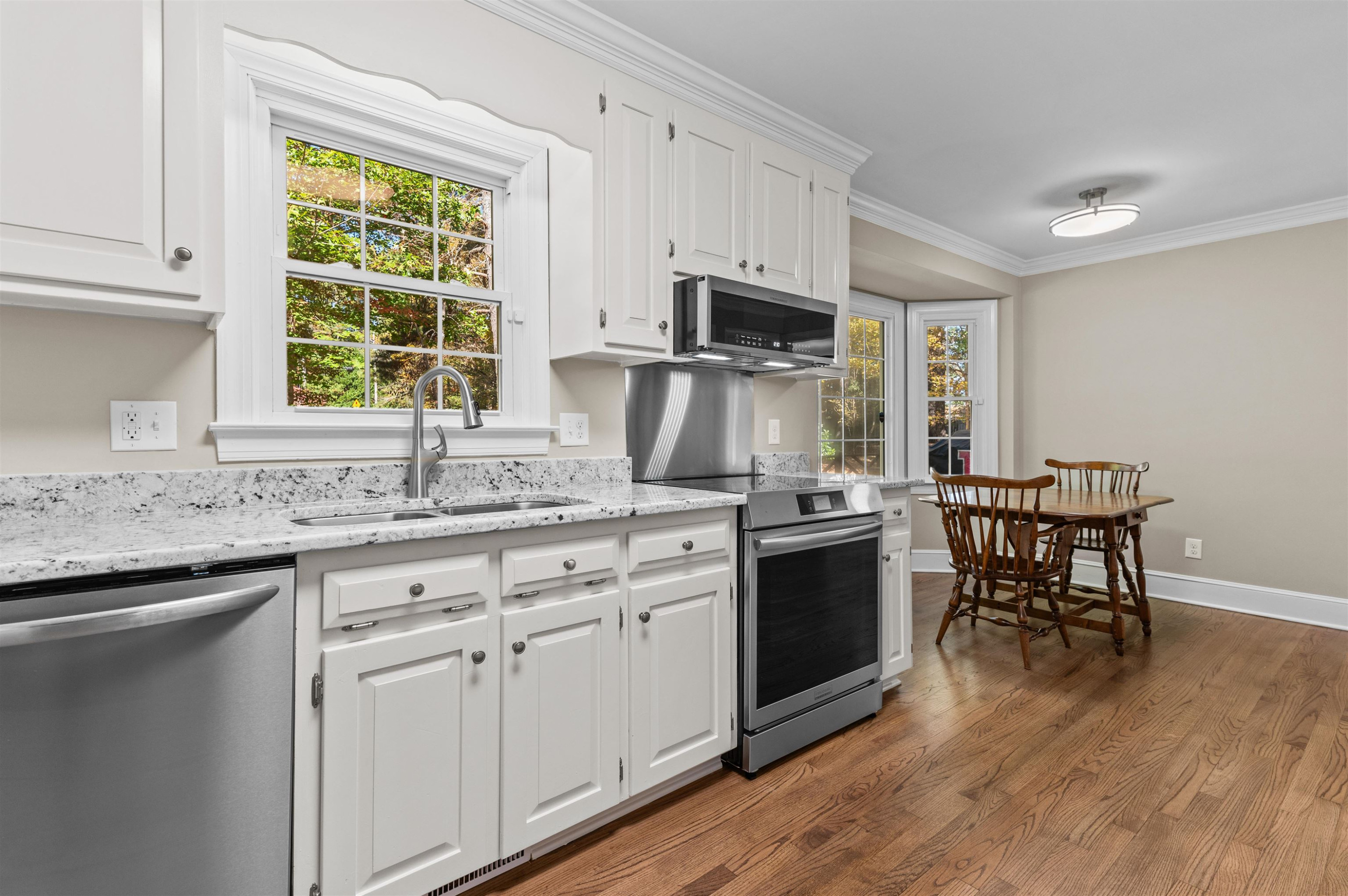 3000 Daventry Lane Raleigh, NC 27613 - Photo 13 of 54 a kitchen with kitchen island granite countertop a sink cabinets and window