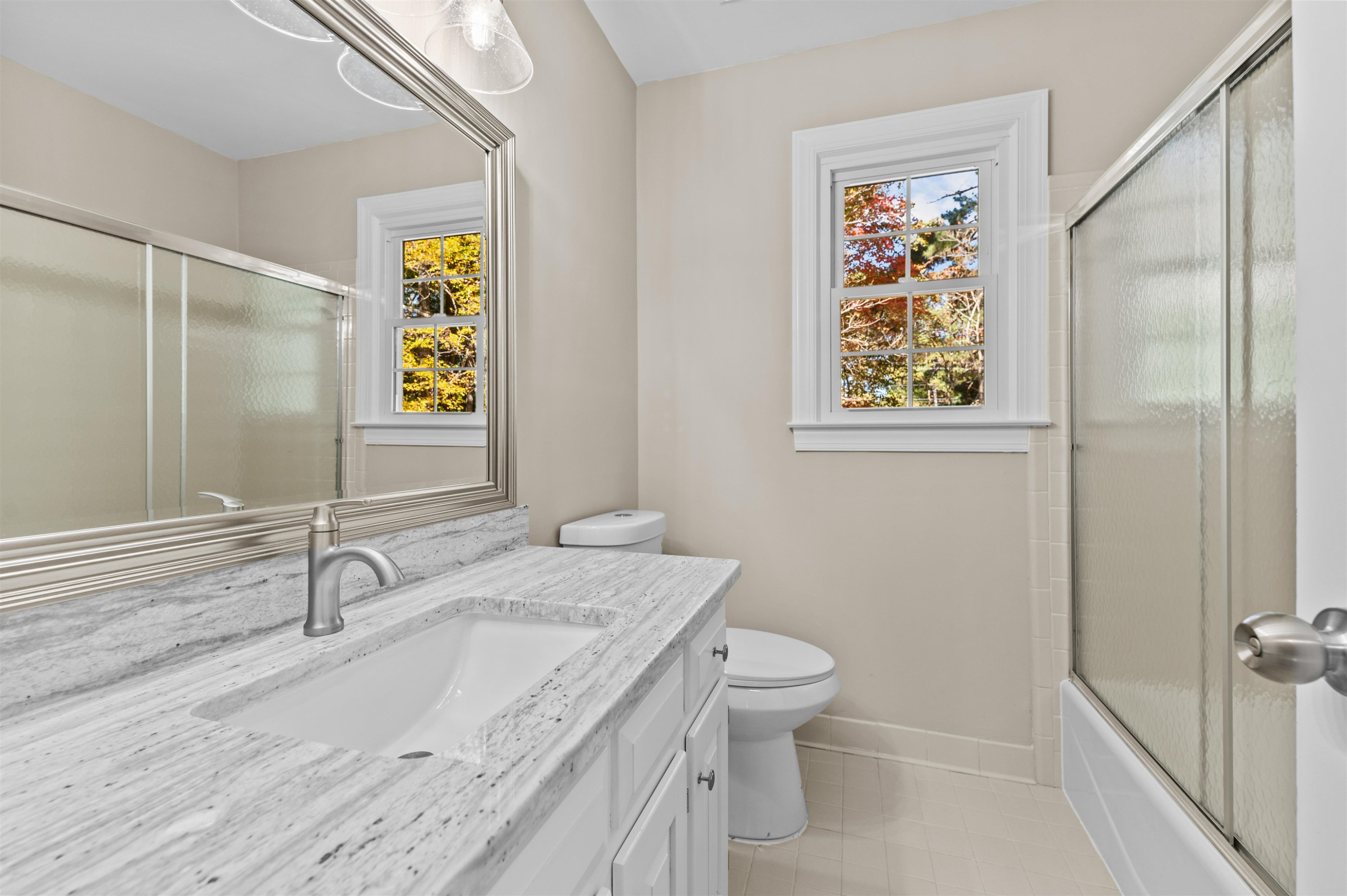 3000 Daventry Lane Raleigh, NC 27613 - Photo 23 of 54 a bathroom with a granite countertop sink and a mirror