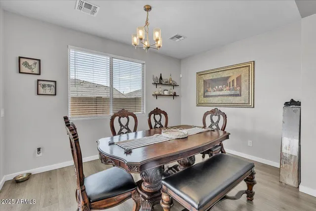 a view of a dining room with furniture wooden floor and a chandelier