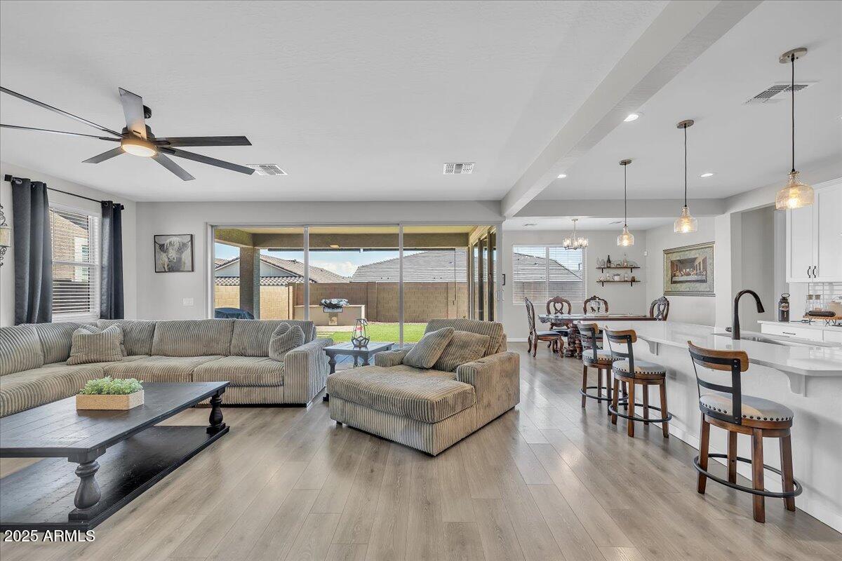 17593 West Red Fox Road Surprise, AZ 85387 - Photo 16 of 55 a living room with furniture kitchen view and a wooden floor