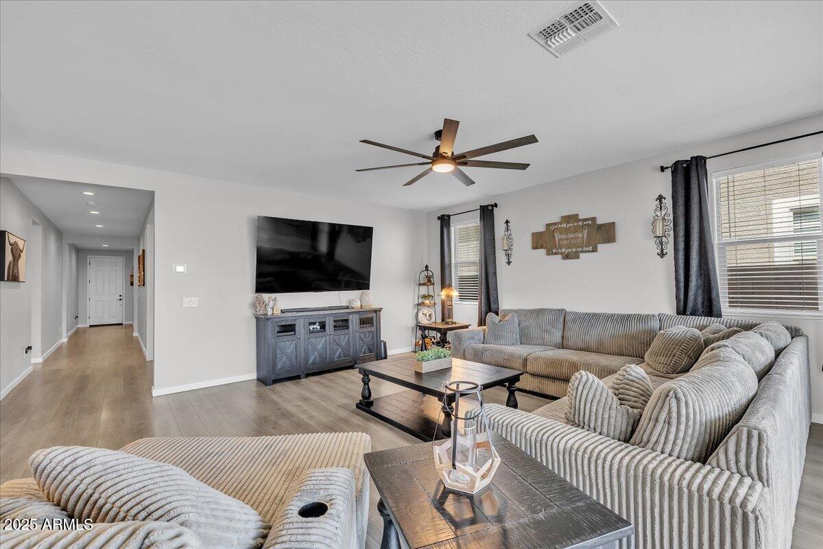 17593 West Red Fox Road Surprise, AZ 85387 - Photo 18 of 55 a living room with furniture and a flat screen tv
