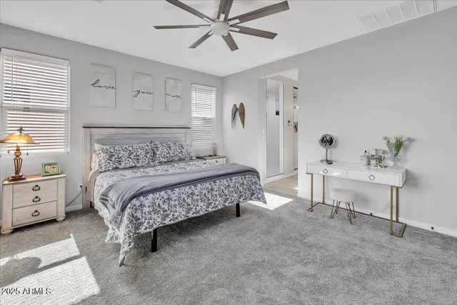 a bedroom with a bed and a large window