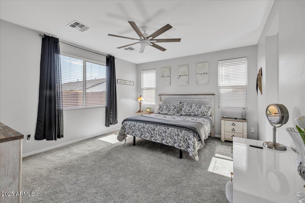 17593 West Red Fox Road Surprise, AZ 85387 - Photo 21 of 55 a bedroom with a bed and a large window