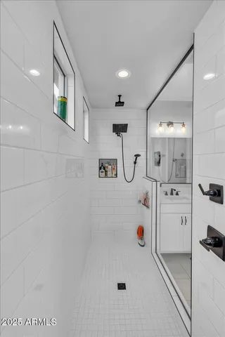 a bathroom with double vanity sinks and a mirror