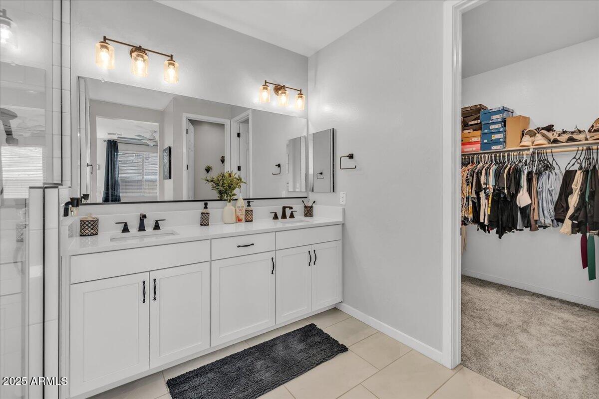 17593 West Red Fox Road Surprise, AZ 85387 - Photo 25 of 55 a spacious bathroom with a double vanity sink a mirror and shower