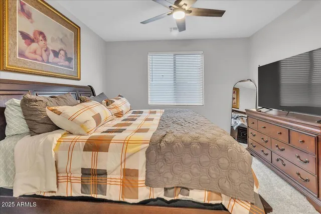 a bedroom with a bed and a chandelier