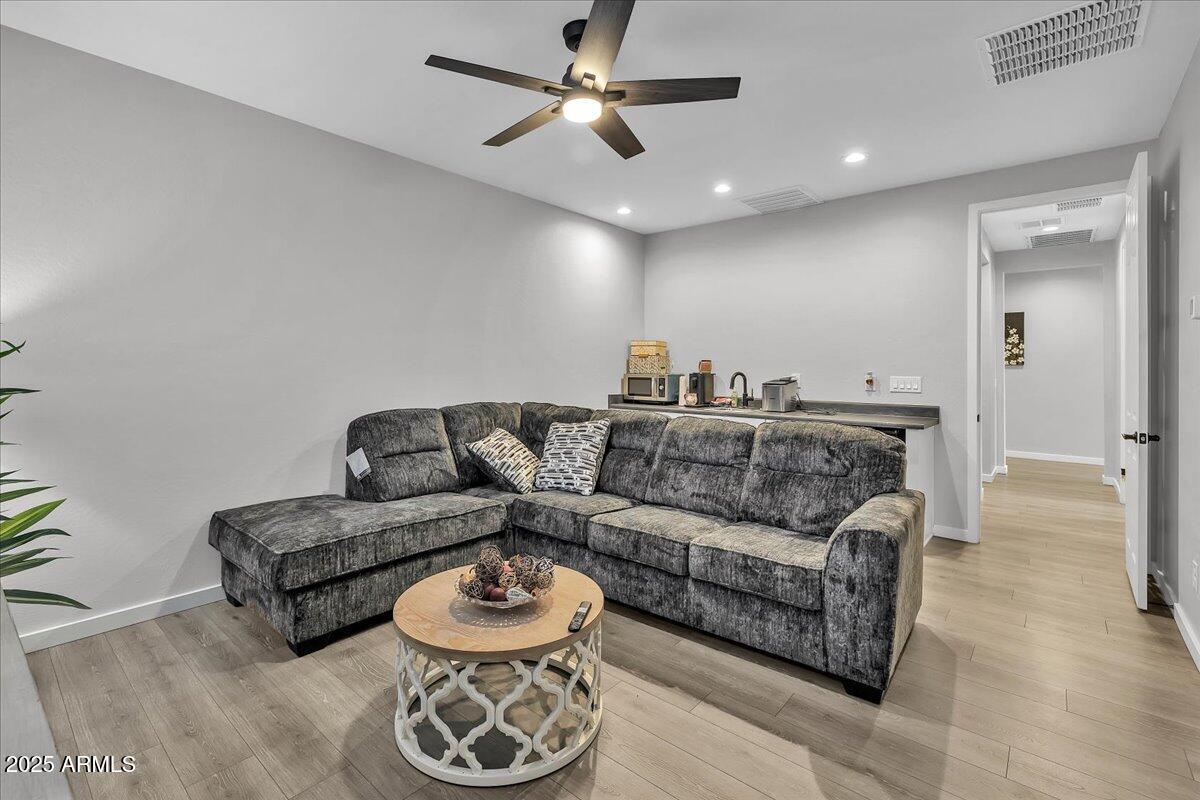 17593 West Red Fox Road Surprise, AZ 85387 - Photo 28 of 55 a living room with furniture and a chandelier