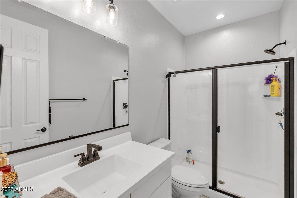 17593 West Red Fox Road Surprise, AZ 85387 - Photo 29 of 55 a bathroom with a sink a toilet and shower