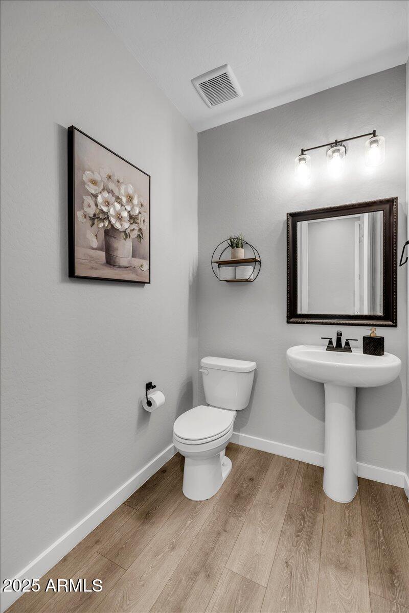 17593 West Red Fox Road Surprise, AZ 85387 - Photo 33 of 55 a bathroom with a toilet a sink and mirror
