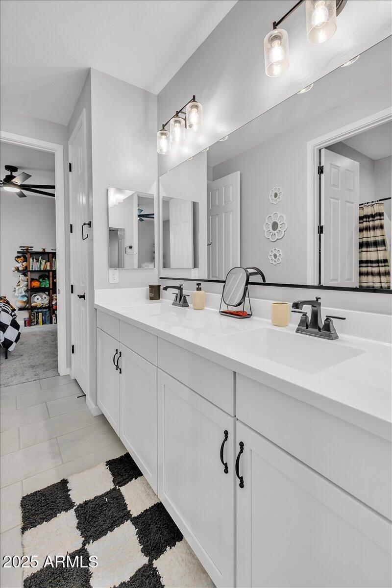 17593 West Red Fox Road Surprise, AZ 85387 - Photo 35 of 55 a bathroom with a double vanity sink mirror and shower