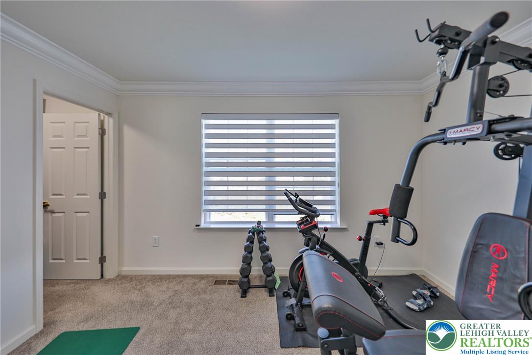 1105 Meco Road Easton, PA 18040 - Photo 62 of 100 Carpeted flooring and elegant crown molding define this versatile fitness space.