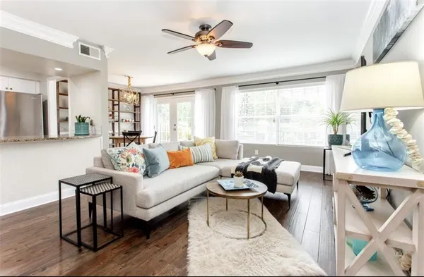 a living room with furniture a table and a large window