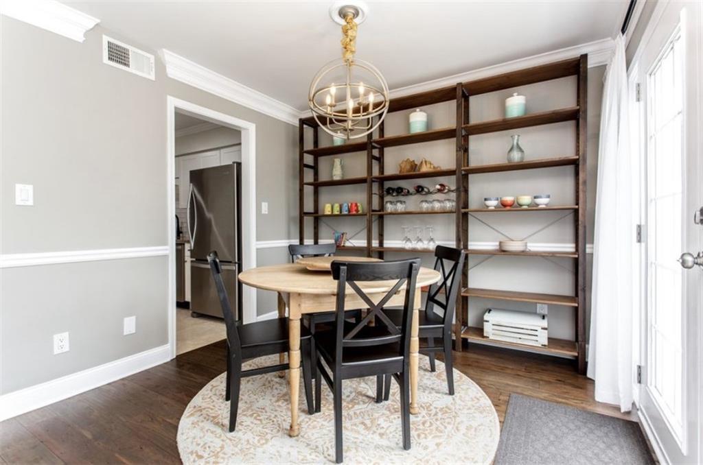 6980 Roswell Road, Unit B6 Atlanta, GA 30328 - Photo 11 of 30 a view of a dining room with furniture and chandelier
