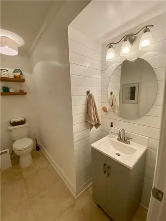 a bathroom with a sink toilet and mirror