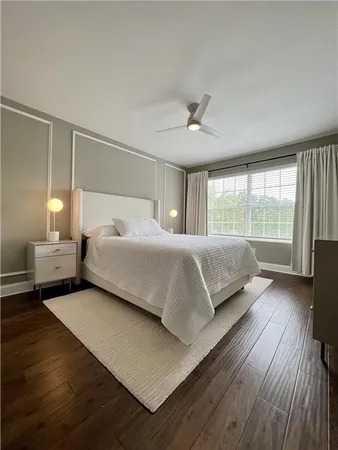 a bedroom with a large bed and a large window