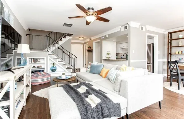 a living room with furniture a fireplace and a flat screen tv