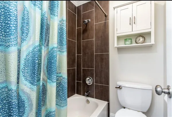 a bathroom with a toilet and shower