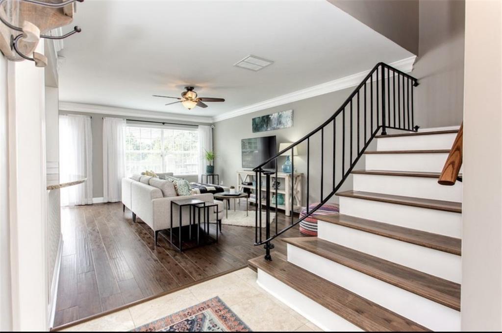 6980 Roswell Road, Unit B6 Atlanta, GA 30328 - Photo 4 of 30 a living room with wooden floor and a dining table