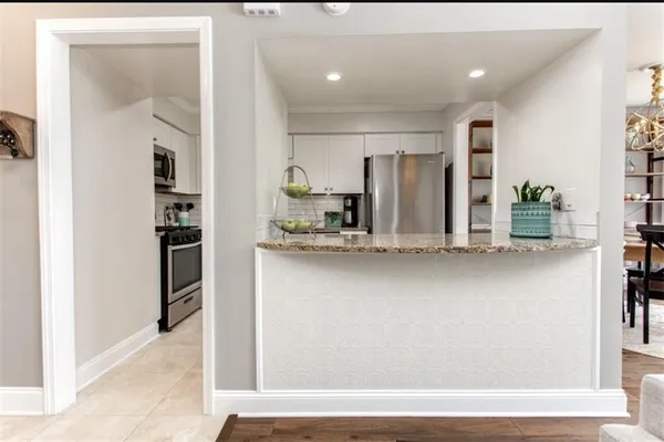a view of kitchen with refrigerator and window