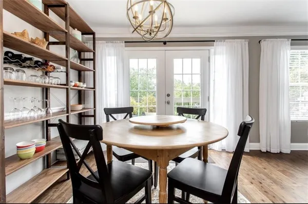 a view of a dining room with furniture and a window