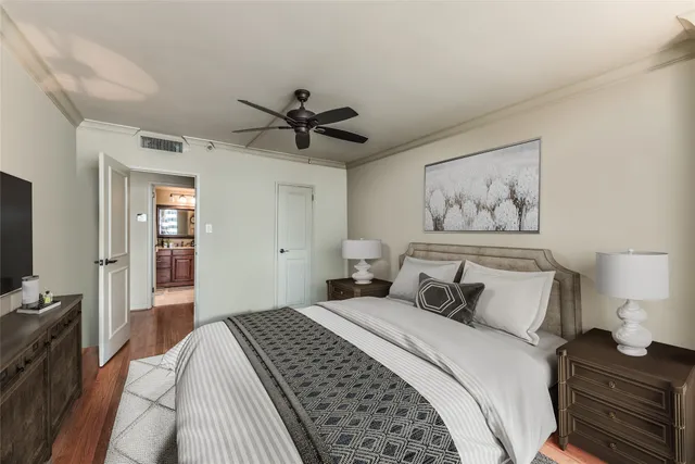 a bedroom with a large bed and a chandelier