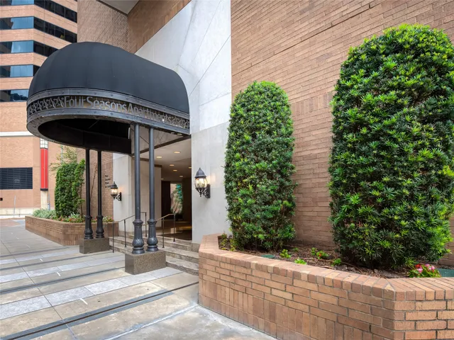 a view of entrance gate of house and tree