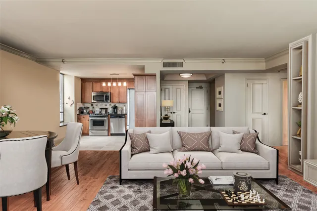 a living room with furniture and kitchen view