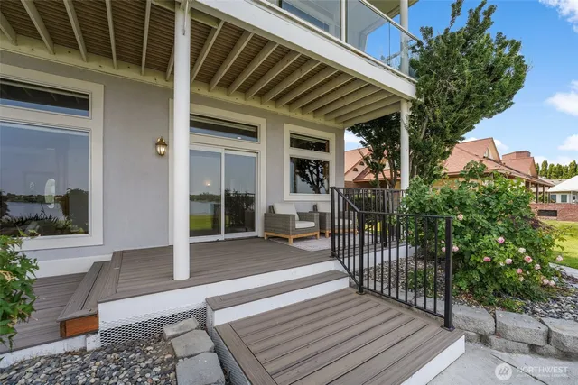 a view of a patio with table and chairs with wooden floor and fence