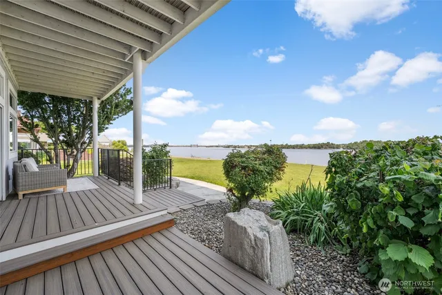 a view of a balcony with lake view and a potted plant