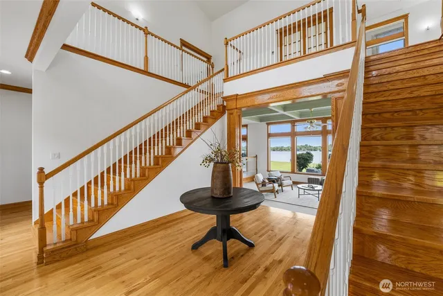a view of entryway and hall with wooden floor