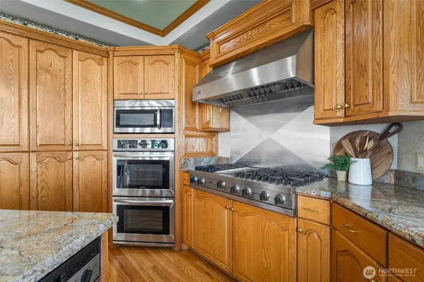 a kitchen with granite countertop a sink and a counter top space