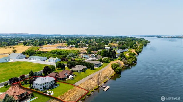 an aerial view of a house with a lake view