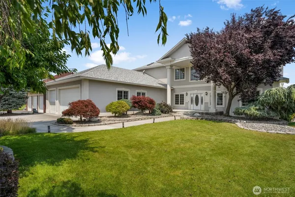 a front view of a house with a garden