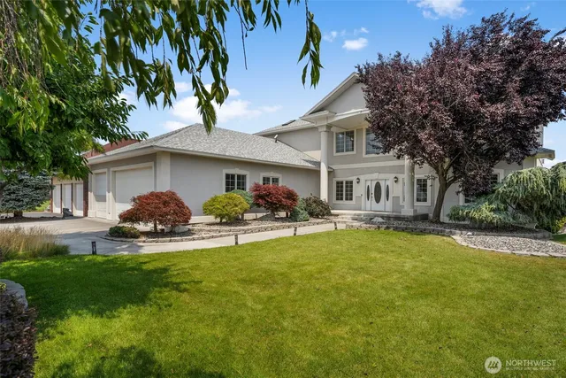 a front view of a house with a garden