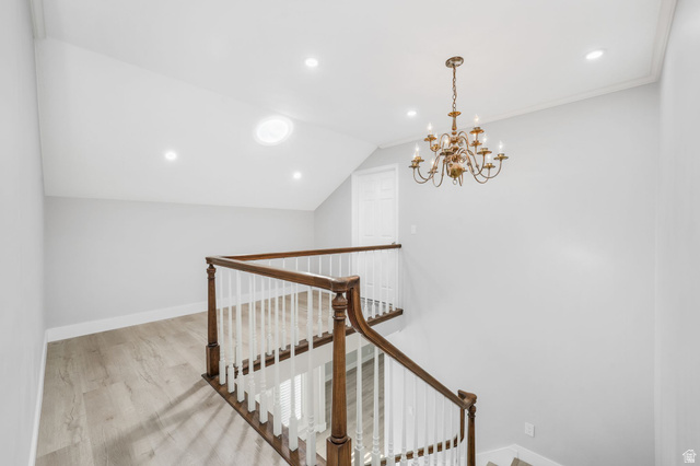 8965 Quail Run Drive Sandy, UT 84093 - Photo 19 of 56 Stairs featuring a chandelier and wood finished floors