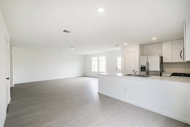 a view of a kitchen with a sink and a large window