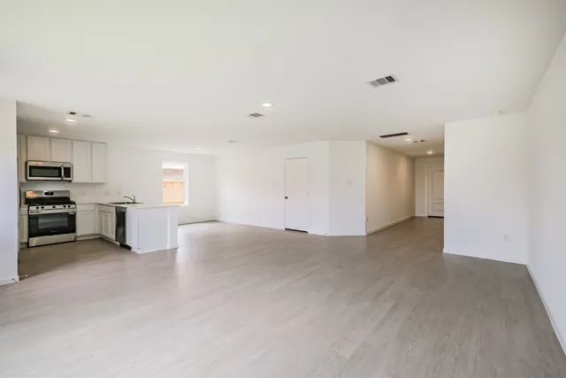 a view of a kitchen with a sink cabinets and a refrigerator