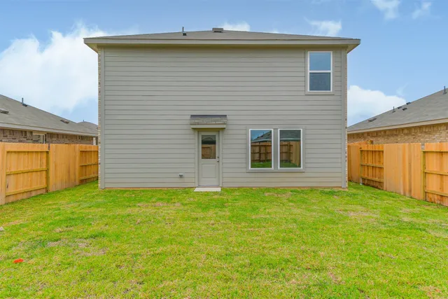 a view of a house with a backyard