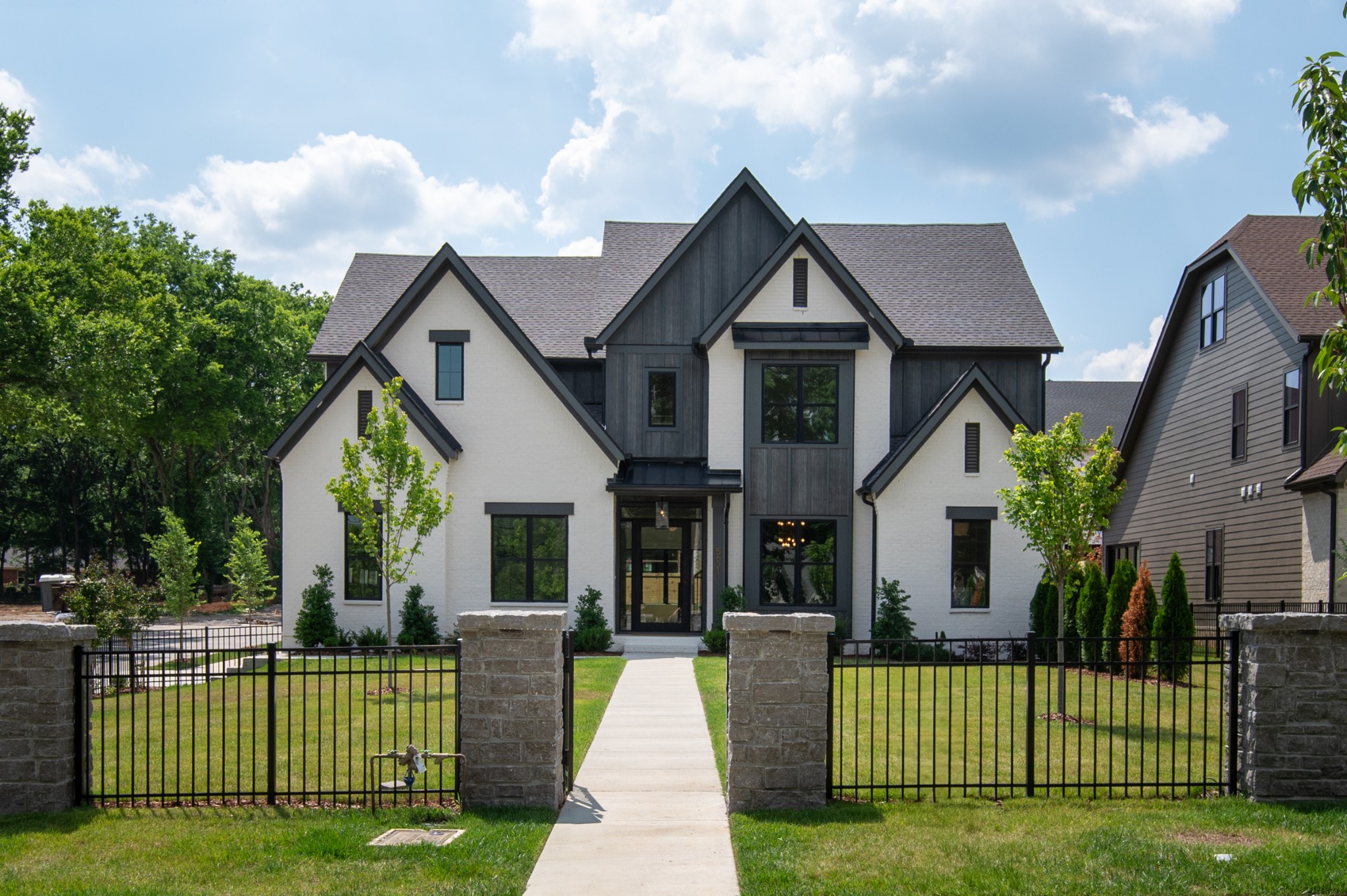 a front view of a house with a garden and plants