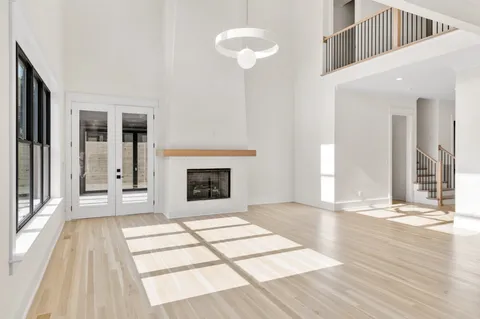 a kitchen with stainless steel appliances granite countertop a sink a stove and a wooden floor